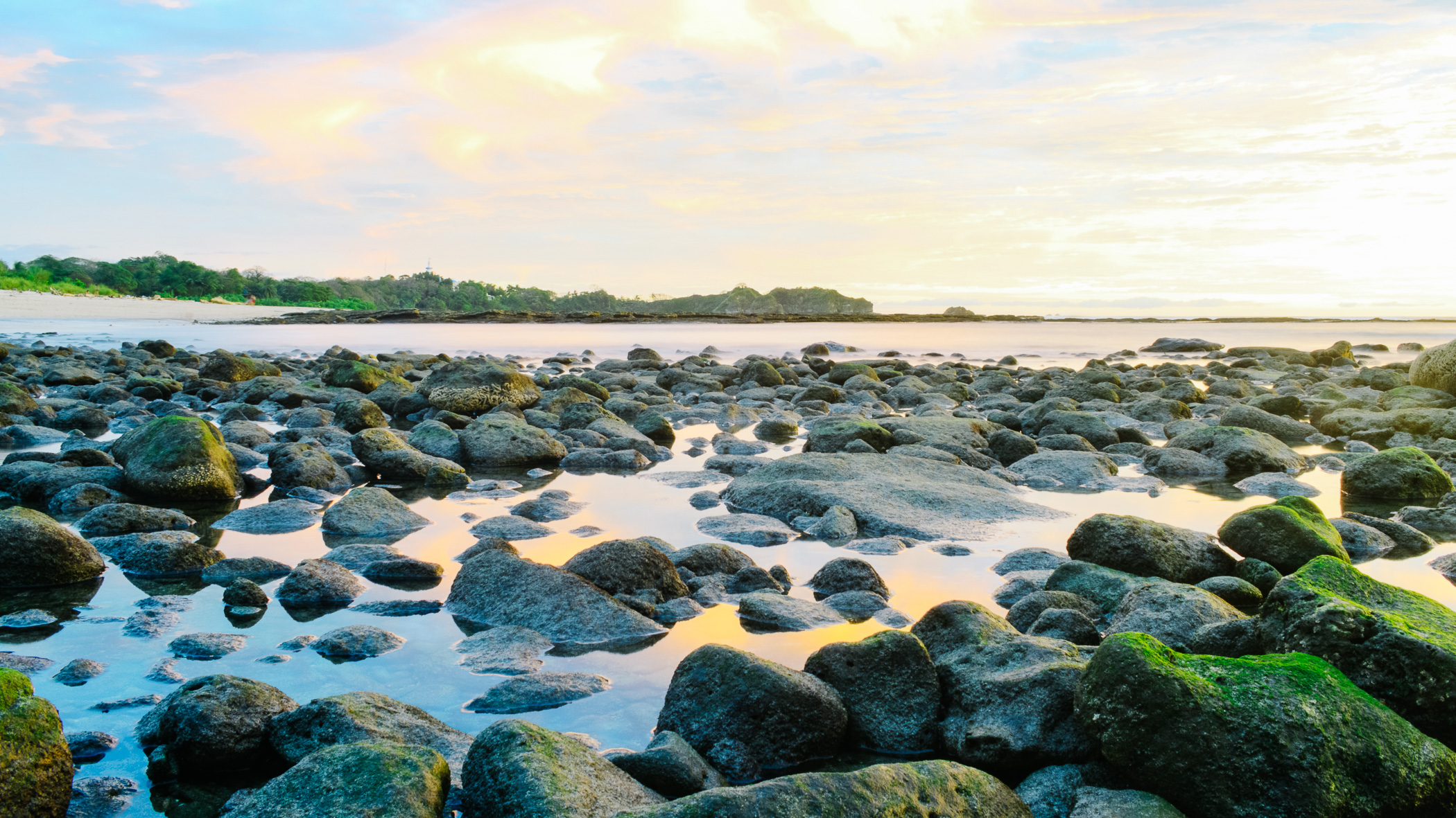 Rocky tide pools at Playa Guiones, Nosara, at golden hour