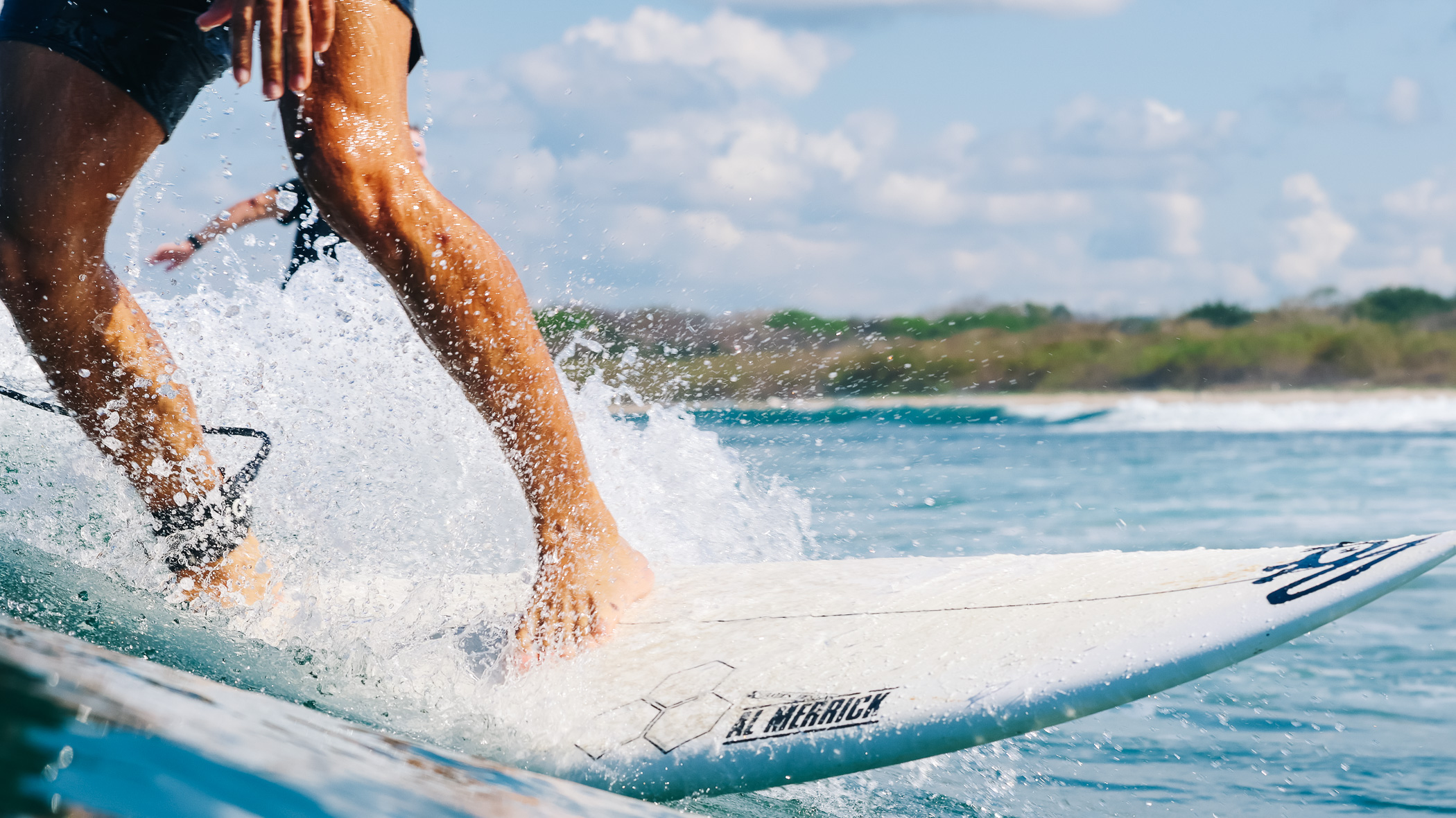 Close-up of a surfer's feet carving a wave at Playa Guiones
