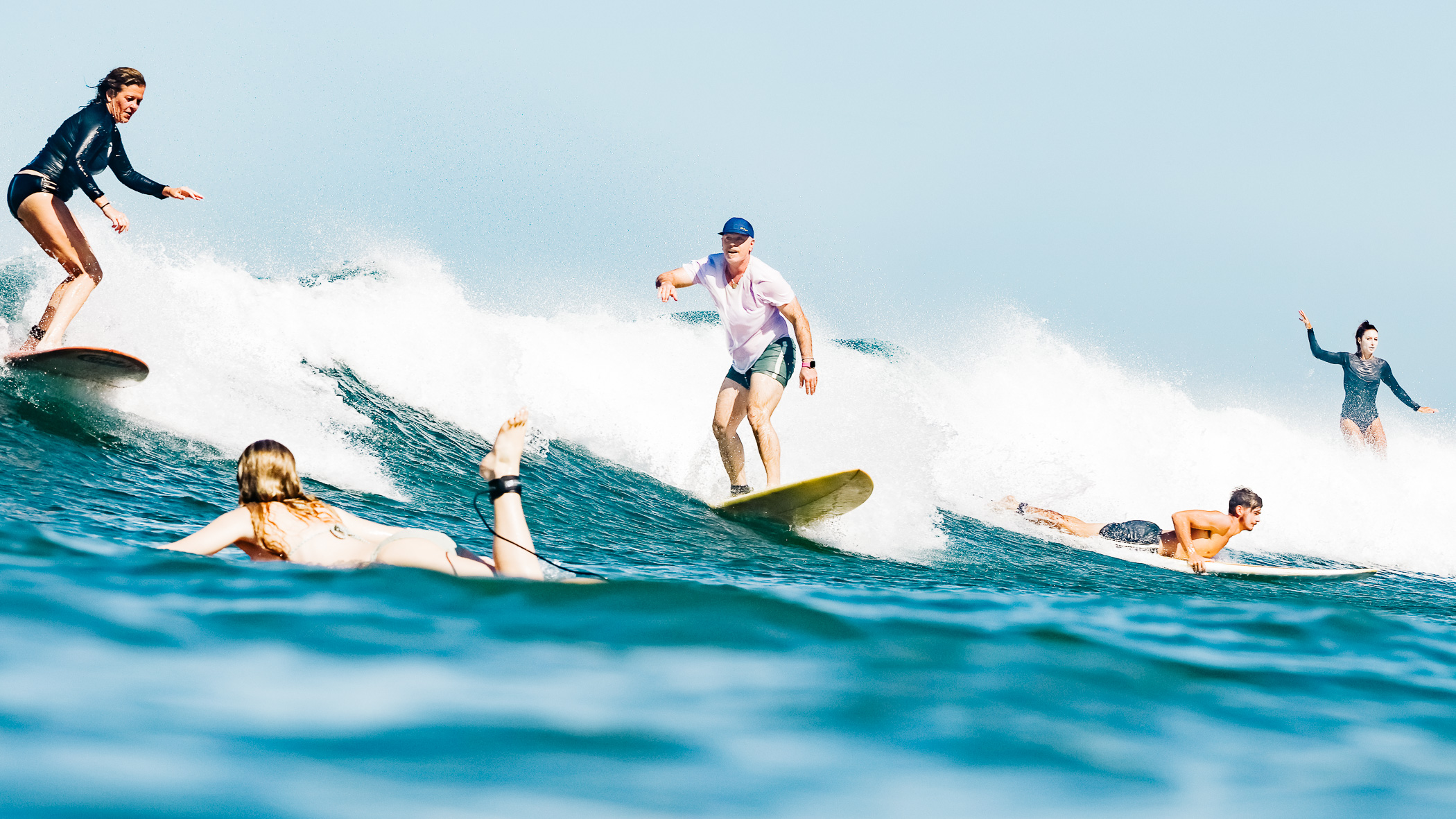 Several surfers sharing a wave at Playa Guiones, shot from the water